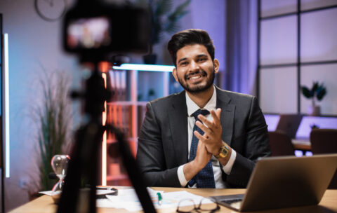 Arab skilled bearded businessman in formal wear recording new video for his internet business course